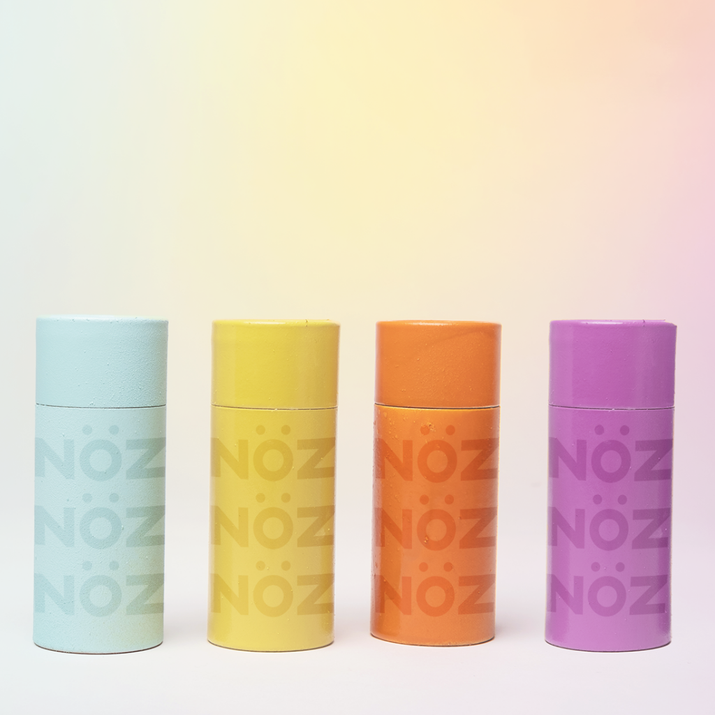 blue, yellow, orange, and purple noz sunscreen standing.